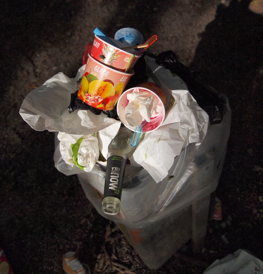 Trash overflowing! After a long weekend, a few articles of trash found their way to the ground. It was all picked up by lunchtime the next day.